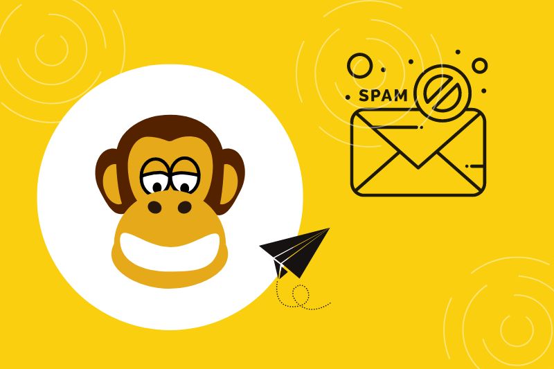 An illustration of an envelope marked with a "No Spam" symbol, on a yellow background with circular patterns—highlighting the concern of Mailchimp emails going to spam.