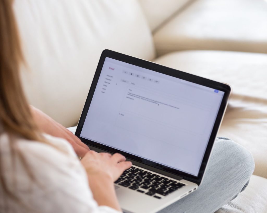 woman working on laptop on sofa