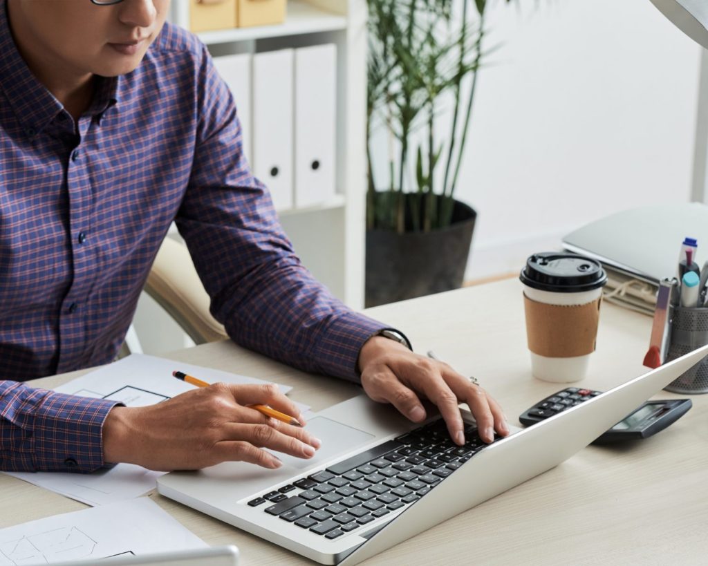 man working at laptop on desk