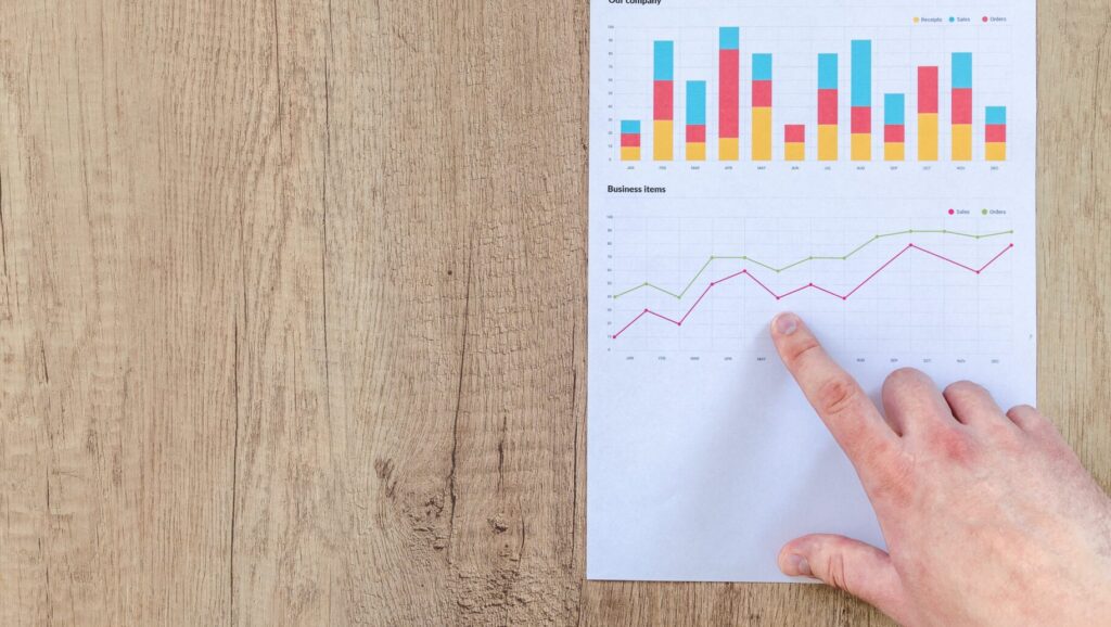 finger pointing to line chart