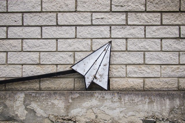 paper airplane against wall