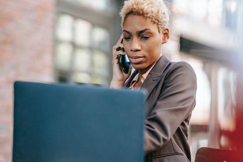 woman making a phone call - Cold Email vs Cold Call