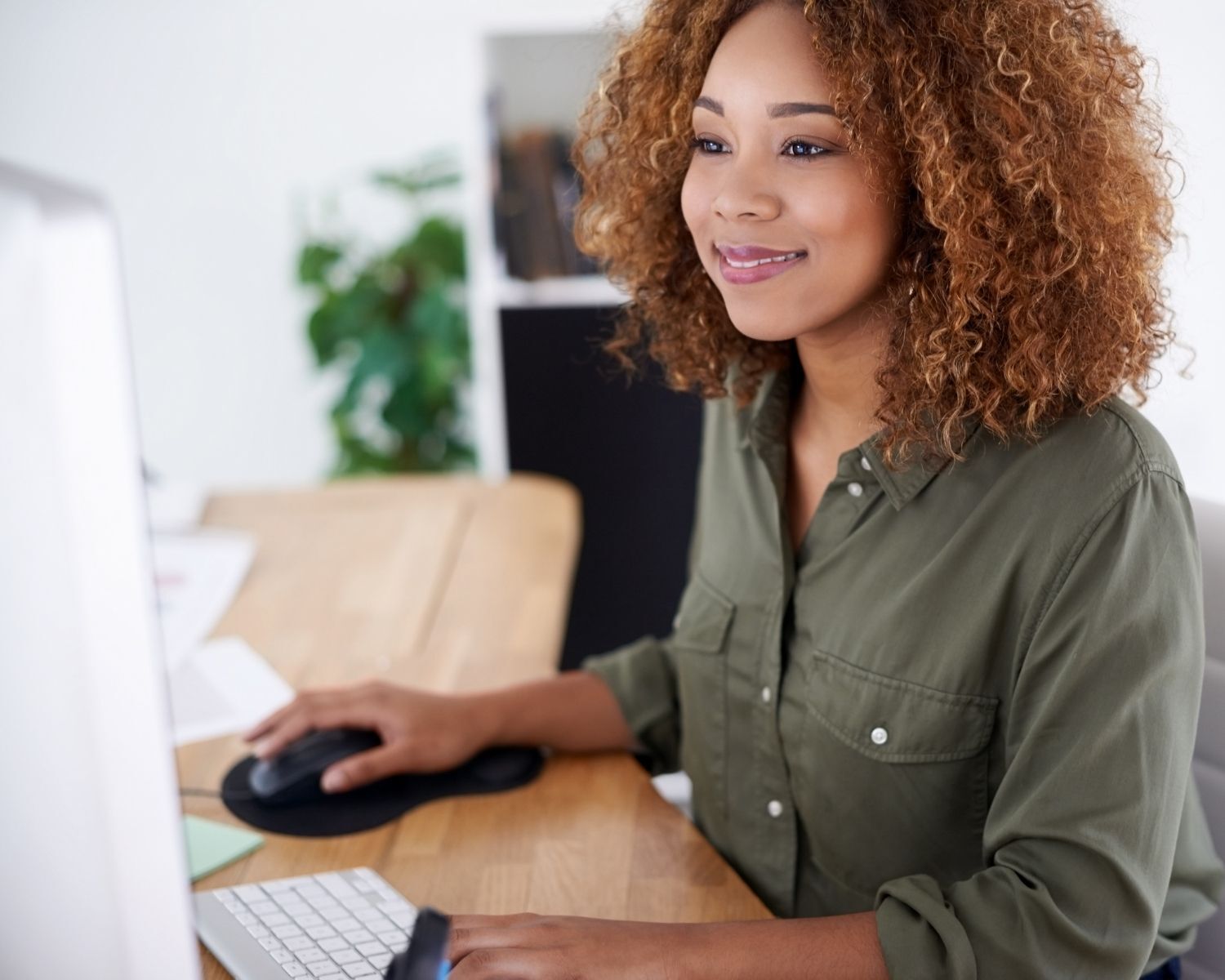 woman working at desktop computer in office