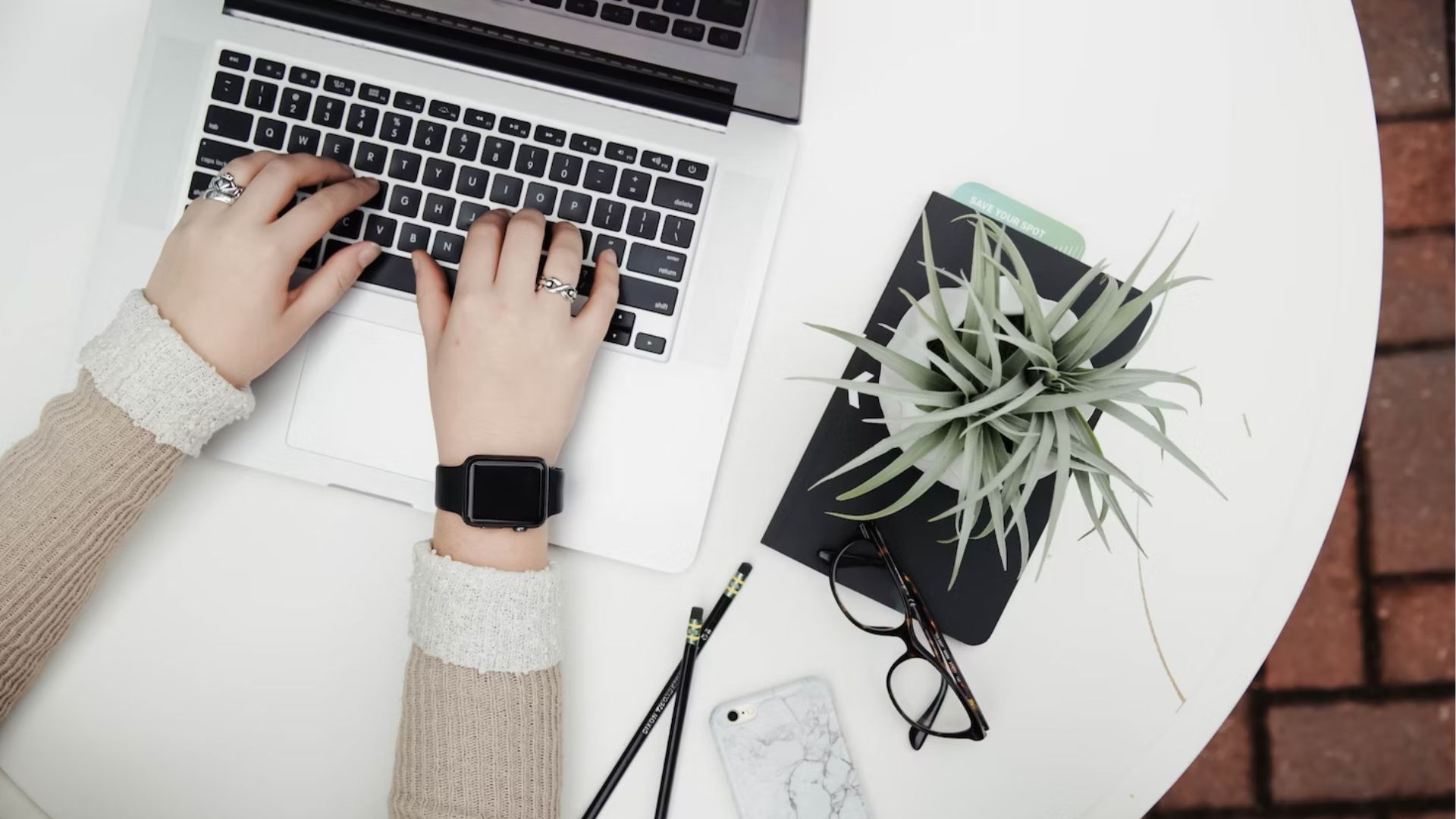 flatlay of laptop and plant - Cold Email Ice Breakers