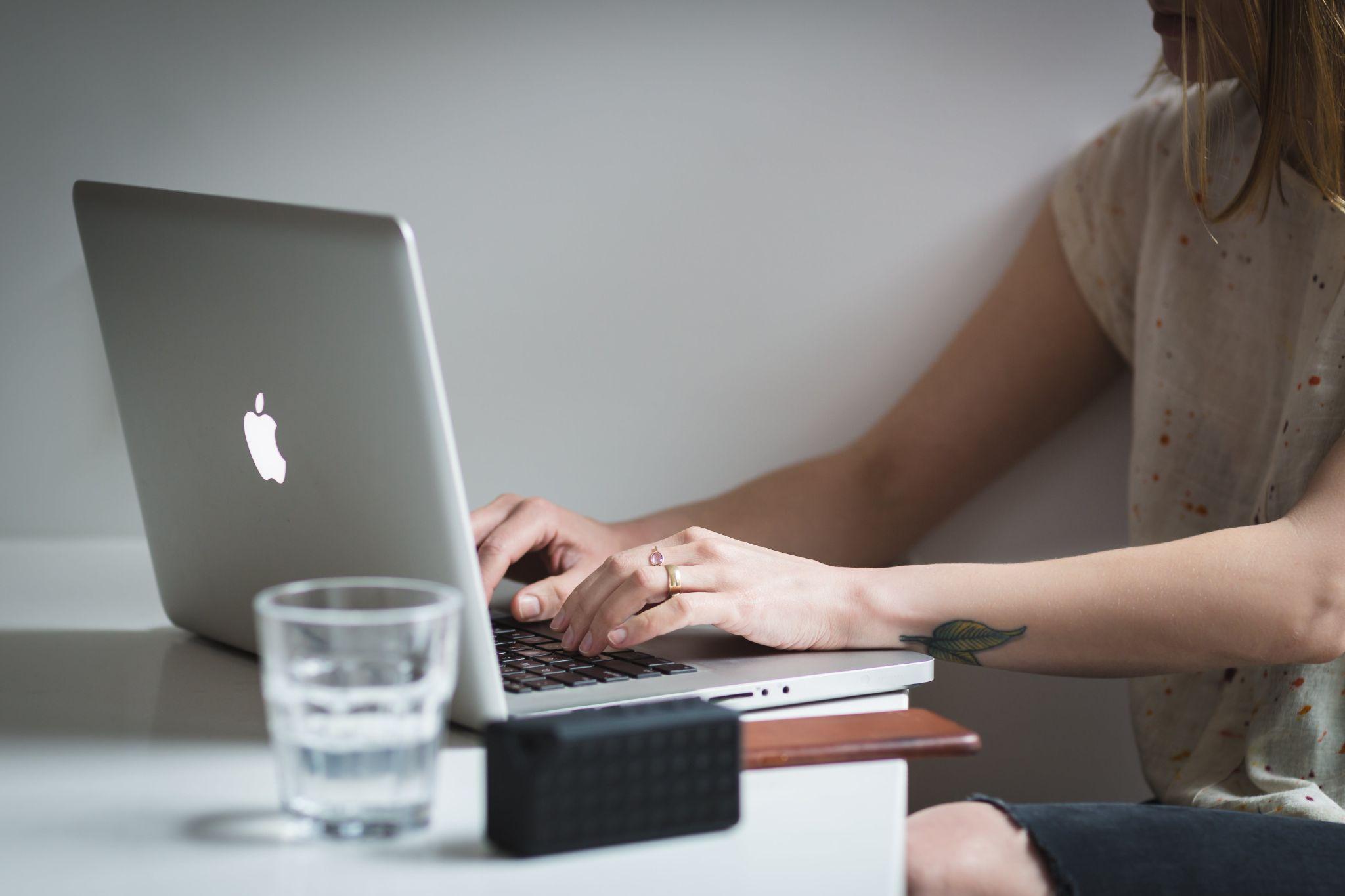 woman typing in her laptop - email deliverability