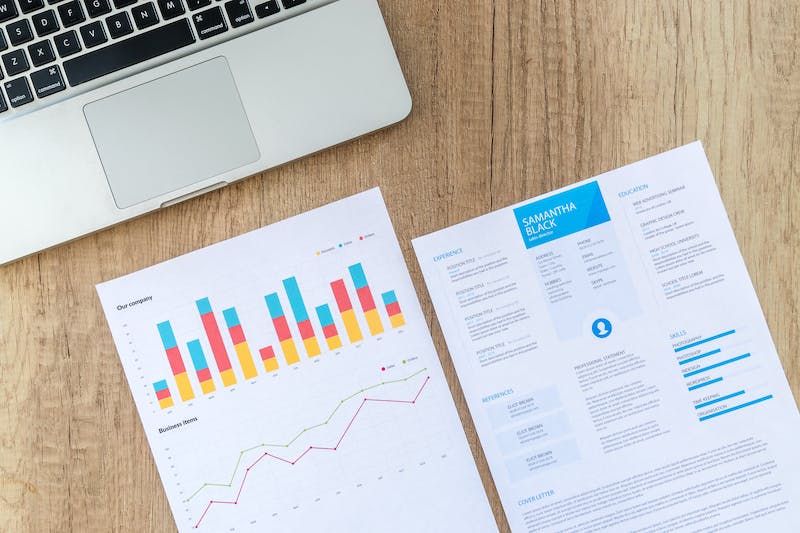 Laptop with printed reports on the desk