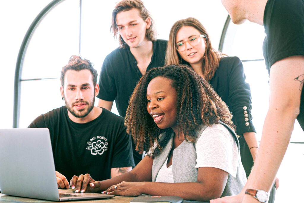 a group of people sending emails on a laptop.