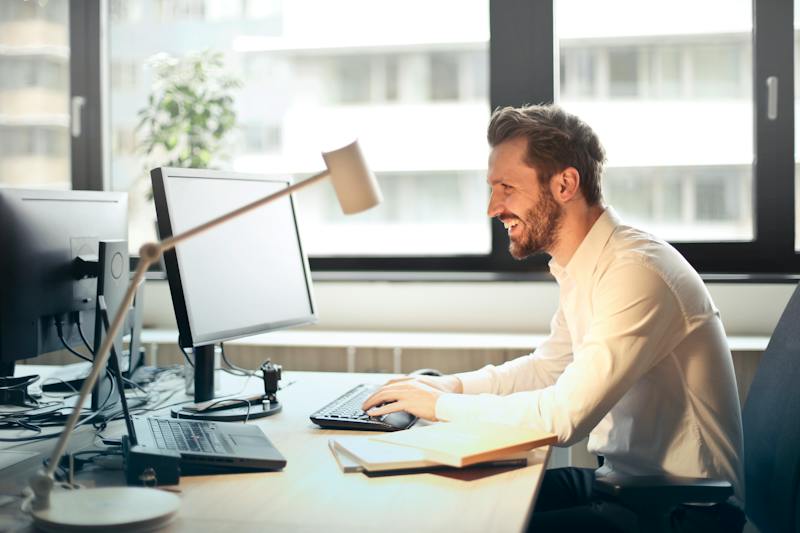 A man working at his computer on an email campaign