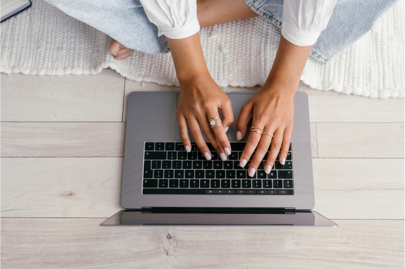 person using a computer keyboard, illustrating the concept of email service providers 