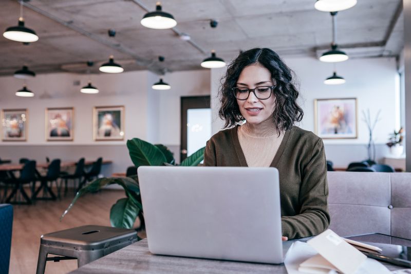 Person using a laptop, exploring the connection between SPF and MX records.