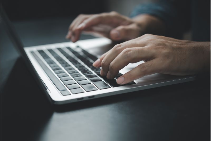 Person using a laptop highlighting the value of DMARC report