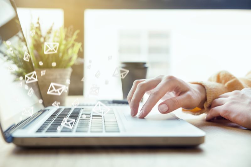 Person composing email on a laptop