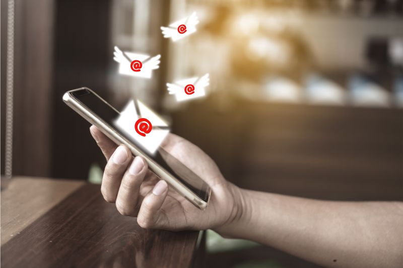 Person checking email notifications in their inbox on a smartphone.