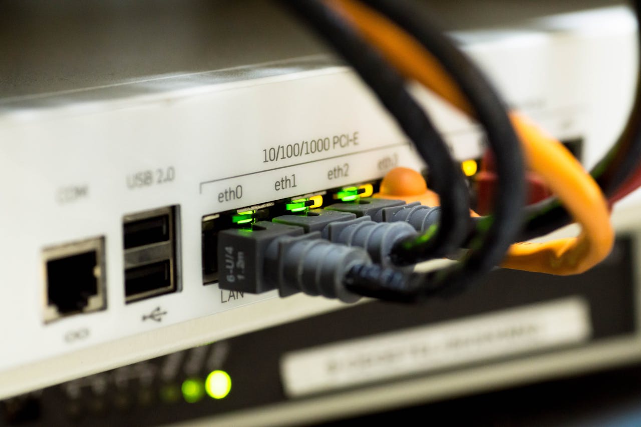 Ethernet cables connected to a network switch showcasing queued Gmail network activity.