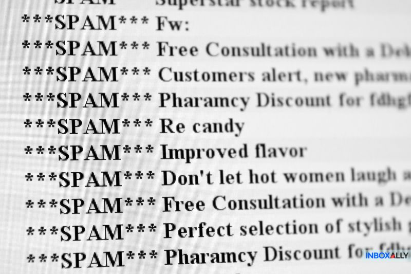 A computer screen shows a list of email subjects marked as spam, packed with offers for consultations, discounts, and more promotional content. It's like when Yahoo is blocking my emails, everything gets lost in the digital shuffle of unwanted messages.