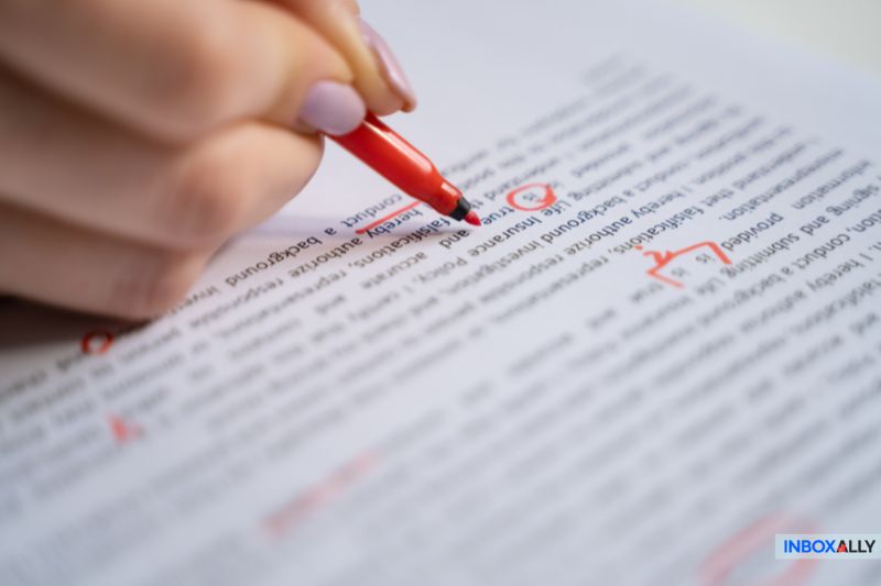 Close-up of red pen marking errors on a document, symbolizing Mailchimp emails going to spam due to content issues and filtering errors