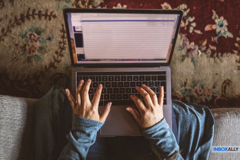 Person typing on a laptop, representing engagement during the email marketing customer journey