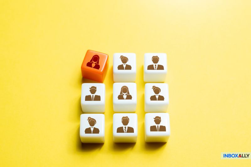 Nine cubes with businesspeople icons sit on a yellow background. Among the eight white cubes, one red cube stands out, symbolizing the unique approach in email lead generation that turns subscribers into loyal customers.