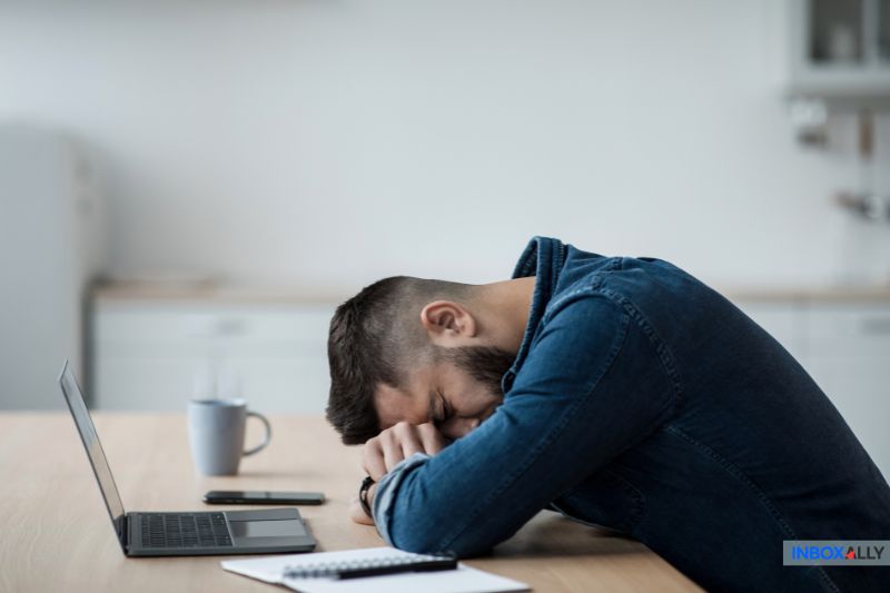 A frustrated user at a desk highlights the importance of understanding 'what is a secure email' for safe communication.