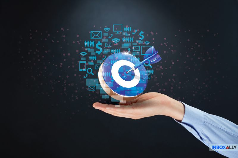 A hand holds a digital target symbol with an arrow, surrounded by various digital icons representing technology and communication, highlighting the precision of effective SEO, where the right keywords hit their mark like a well-aimed arrow.