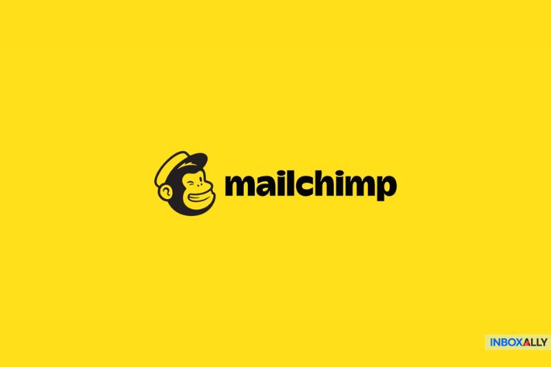 Yellow background with the Mailchimp logo, featuring a monkey face wearing a hat next to the text "mailchimp," showcasing its playful edge among AWeber Competitors.