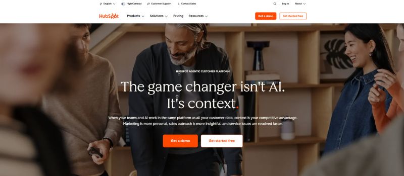 A group of people works together in an office, with text overlay promoting HubSpot's customer platform, the importance of context in marketing, and the benefits of Best Email Automation for streamlined campaigns.